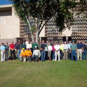 A large group of people pose for a Tree City USA photo.